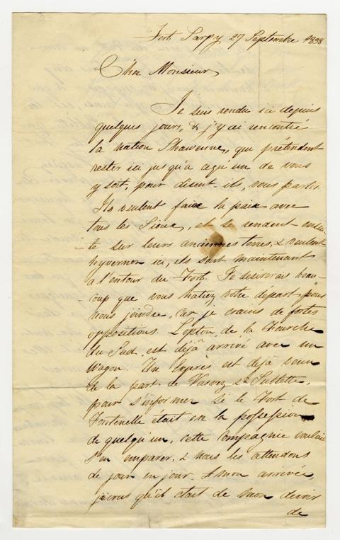 Half sheet of lined paper with ornate cursive writing in ink