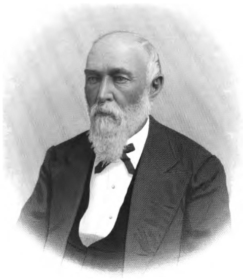 portrait of a balding man with white beard and moustache, wearing a white shirt with a three piece suit and ribbon tie