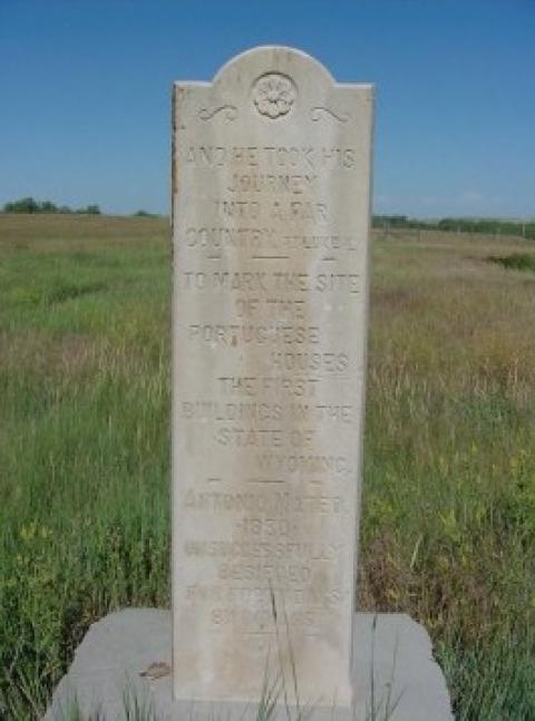 stone monumnet engraved with the words, "and he took his journey into a far country ... to mark this site of the Portuguese Houses, the first buildings in the State of Wyoming..."