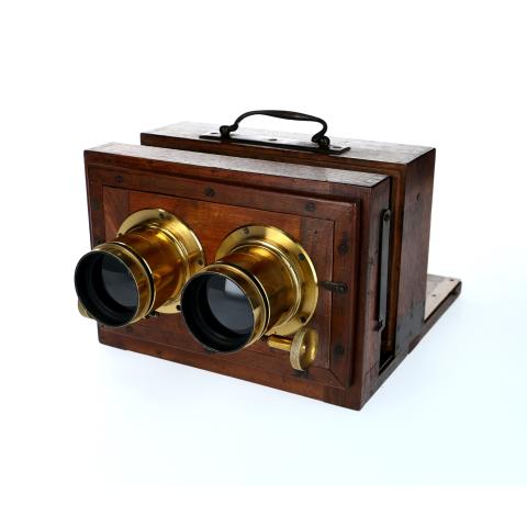 wood box camera with two protruding lenses and a handle on top